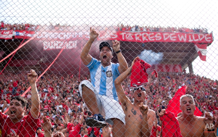 Independiente's fans celebrate their team's fourth goal during an Argentine league soccer match against Racing Club in Buenos Aires, Argentina, Saturday April 14, 2012. Independiente won 4-1. (AP Photo/Natacha Pisarenko)