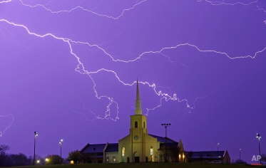 Lightning steaks across the sky behind the Young Meadows Presbyterian Church in Montgomery, Ala., Monday, March 18, 2013. (AP Photo/Dave Martin)