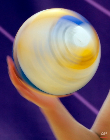 April Ross of the United States spins the ball during a beach volleyball match against Spain at the 2012 Summer Olympics, Thursday, Aug. 2, 2012, in London. (AP Photo/Dave Martin)