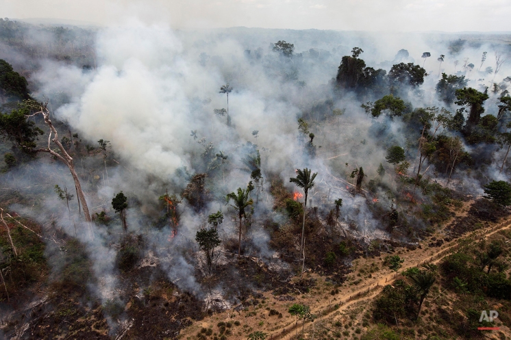 In this Sept. 15, 2009, photo a forest in the Amazon is seen being illegally burnt, near Novo Progresso, in the northern Brazilian state of Para. The cutting of trees, scientists say, is hindering the immense jungle’s ability to absorb carbon from the air and to pull enough water through tree roots to supply gigantic “sky rivers” that move more moisture than the Amazon river itself. More than two-thirds of the rain in southeastern Brazil, home to 40 percent of its population, comes from these sky rivers, studies estimate. When they dry up, drought follows, scientists believe. (AP Photo/Andre Penner)