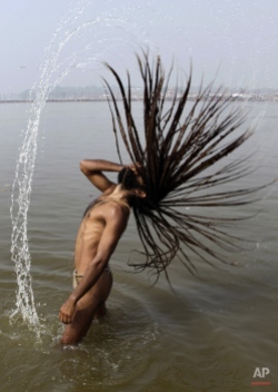 A Hindu holy man takes a dip at Sangam, the confluence of the Ganges and Yamuna rivers on the auspicious day of Basant Pachami during the month long 'Magh Mela' in Allahabad, India, Wednesday, Jan. 20, 2010. Hundreds of thousands of devout Hindus take a bath at the confluence during the astronomically auspicious period of over 30 days celebrated as 'Magh Mela', to rid themselves of their sins and attain prosperity. (AP Photo/Rajesh Kumar Singh)