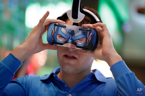 A brand ambassador tests Samsung's Gear VR headset at the Samsung Galaxy booth at the International CES Tuesday, Jan. 6, 2015, in Las Vegas. (AP Photo/Jae C. Hong)
