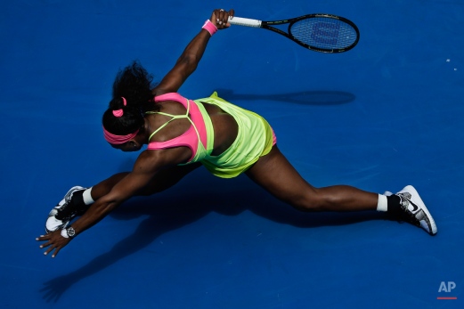 Serena Williams of the U.S. stretches out for a shot to Garbine Muguruza of Spain during their fourth round match at the Australian Open tennis championship in Melbourne, Australia, Monday, Jan. 26, 2015. (AP Photo/Bernat Armangue)
