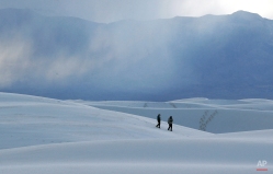 Visitors walk on a sand dune at dusk, Wednesday, March 4, 2015, in White Sands National Monument, N.M. (AP Photo/Patrick Semansky)