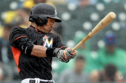 Miami Marlins' Ichiro Suzuki swings in a steady rain during the fourth inning of an exhibition spring training baseball game against the New York Mets Saturday, March 7, 2015, in Jupiter, Fla. (AP Photo/Jeff Roberson)