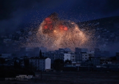 In this Monday, Oct. 20, 2014 photo, thick smoke and flames from an airstrike by the U.S.-led coalition rise in Kobani, Syria, as seen from a hilltop on the outskirts of Suruc, at the Turkey-Syria border. (AP Photo/Lefteris Pitarakis)
