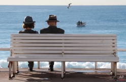 People sit on a bench on the promenade des Anglais in Nice, southeastern France, Wednesday, Feb. 25, 2015. Temperatures in the area rose to 16 degrees Celsius (60 Fahrenheit). (AP Photo/Lionel Cironneau)