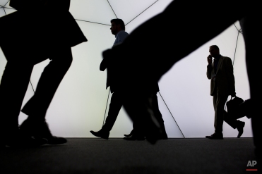 Visitors walk inside a pavilion at the Mobile World Congress, the world's largest mobile phone trade show in Barcelona, Spain, Tuesday, March 3, 2015. (AP Photo/Emilio Morenatti)