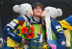 Mac Bohonnon, center, is kissed by Ashley Caldwell, right, and Kiley McKinnon, left, all of the U.S, as they stand on a podium celebrating their victory in the FIS Freestyle Ski World Cup 2015 event in Raubichi, on the outskirts of Minsk, Belarus, Sunday, March 1, 2015. Ashley Caldwell took gold, Mac Bohonnon and Kiley McKinnon took silver. (AP Photo/Sergei Grits)