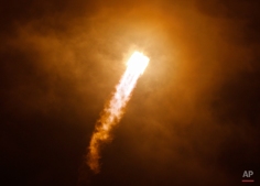 The Soyuz-FG rocket booster with Soyuz TMA-16M space ship carrying a new crew to the International Space Station, ISS, flies in the sky at the Russian leased Baikonur cosmodrome, Kazakhstan, Saturday, March 28, 2015. The Russian rocket carries U.S. astronaut Scott Kelly, Russian cosmonauts Gennady Padalka and Mikhail Korniyenko. (AP Photo/Dmitry Lovetsky)