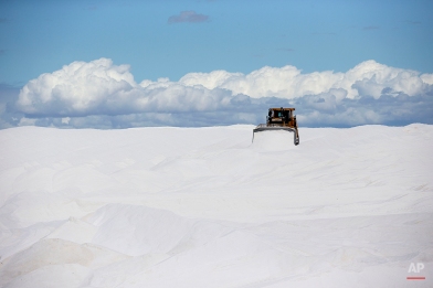 A bulldozer moves salt for loading onto barges, at the Salt Export Co. (ESSA), port installations, in Guerrero Negro, Mexico’s Baja California peninsula, March 3, 2015. The largest salt-making facility on the planet is located here. The salt is extracted from ocean water by evaporation, taking advantage of the region’s low yearly rainfall, large areas of flat lands and high solar radiation. (AP Photo/Dario Lopez-Mills)