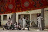 Chadian troops watch others participate in the closing ceremony of operation Flintlock in an army base in N'djamena, Chad, Monday, March 9, 2015. The U.S. military and its Western partners conduct this training annually and set up plans long before Boko Haram began attacking its neighbors Niger, Chad and Cameroon. Chadian Brig. Gen. Zakaria Ngobongue said Monday that his soldiers alongside troops from Niger had entered Nigeria but he declined to give further details about the ongoing operation. Ngobongue described Boko Haram fighters as "bandits and criminals who have nothing to do with religion." (AP Photo/Jerome Delay)
