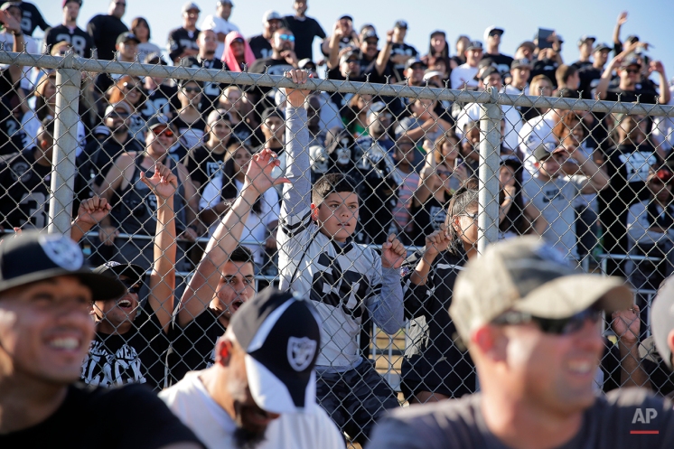 Oakland Raiders fans watch during the team's joint football practice with the Dallas Cowboys on Aug. 12, 2014, in Oxnard, Calif. (AP Photo/Jae C. Hong)