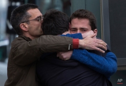Family members of people involved in a crashed plane comfort each other as they arrive at the Barcelona airport in Spain, Tuesday, March 24, 2015. A Germanwings passenger jet carrying more than 140 people crashed in the French Alps region as it traveled from Barcelona to Duesseldorf in Germany. (AP Photo/Emilio Morenatti)