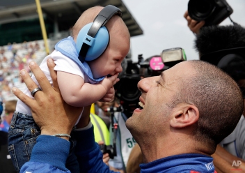 Tony Kanaan, of Brazil, picks up his son Deco after qualifying for the Indianapolis 500 auto race at Indianapolis Motor Speedway in Indianapolis, Sunday, May 17, 2015. (AP Photo/AJ Mast)