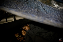 A Nepalese family sleeps sheltered by plastic sheets in an open space after an earthquake hit the region earlier in the day, in Kathmandu, Nepal, Tuesday, May 12, 2015. A new earthquake Tuesday spread more fear and misery in Nepal, which is still struggling to recover from a devastating quake nearly three weeks ago that left thousands dead. (AP Photo/Bernat Amangue)