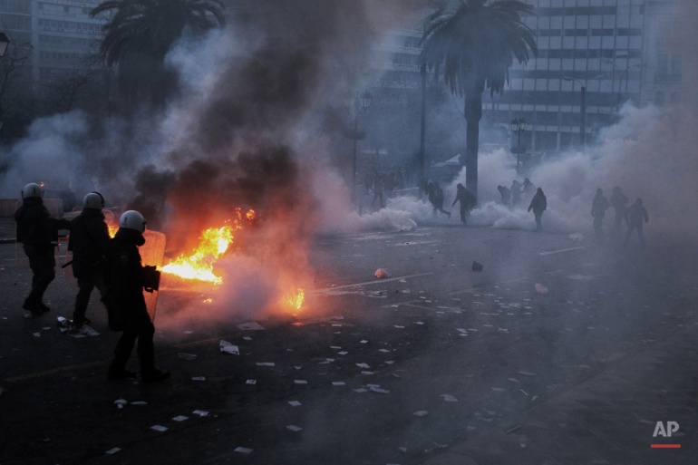 In this Feb. 12, 2012 photo, riot police clash with protesters in central Athens, as lawmakers prepared for a historic parliamentary vote on harsh austerity measures demanded to keep the country solvent and within the eurozone. (AP Photo/Petros Giannakouris)