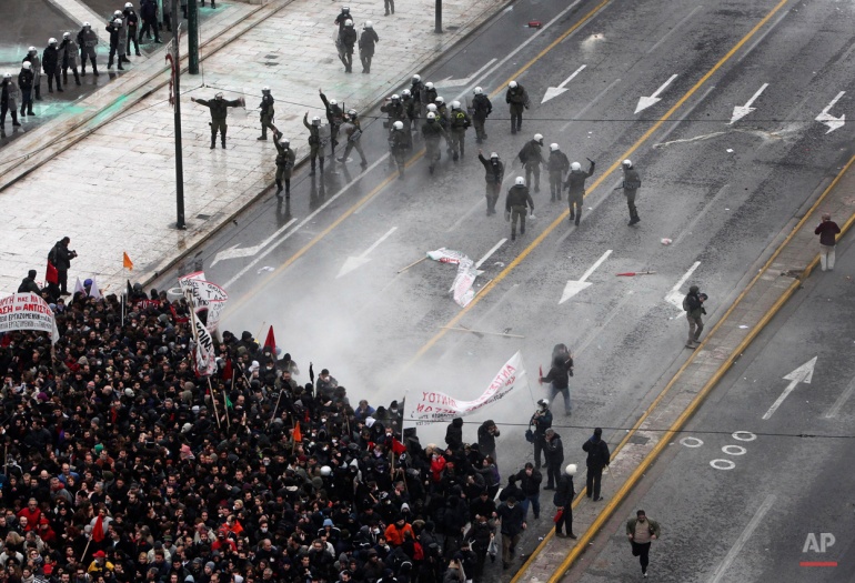 In this Dec. 15, 2010, photo riot police clash with protesters outside the Greek Parliament in central Athens. (AP Photo/Petros Giannakouris)