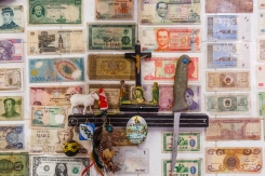 An image of Christ is placed on a wall covered in banknotes in a market in Athens, Tuesday, June 23, 2015. Greece this week offered a series of measures, including multiple tax increases, to persuade its creditors to release bailout funds and keep the country from defaulting on its debts as soon as next week. (AP Photo/Daniel Ochoa de Olza)