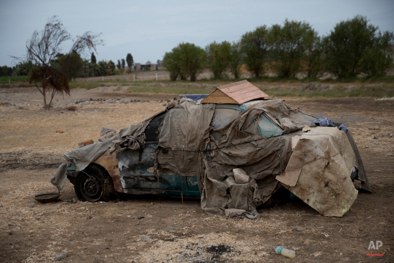 This May 29, 2015 photo shows an abandoned car in Punta Bombon in Tambo Valley, Arequipa, Peru. Residents of the coastal valley of southern Peru believe a projected copper extraction project will pollute their crops and destroy their way of life. They feel betrayed by the president and many vow to keep up resistance. (AP Photo/Rodrigo Abd)