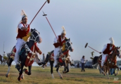 Pakistani horse riders target wooden pegs during a tent pegging competition arranged by the Pakistan Tent Pegging Association in Islamabad, Pakistan, June 14, 2015. (AP Photo/Anjum Naveed)