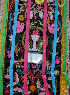 This June 7, 2015 photo shows an embroidered collage of Catholic and indigenous symbols that intermingle on a dancer's costume, in Pujili, Ecuador. (AP Photo/Dolores Ochoa)