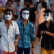 Pakistani youths wear masks as they visit the Lake View picnic area to celebrate Eid al-Fitr holidays in Islamabad, Pakistan, Sunday, July 19, 2015. The three-day holidays of Eid al-Fitr marks the end of the holy fasting month of Ramadan. (AP Photo/Anjum Naveed)