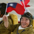 Taiwan's WWII military veterans wave to spectators during a massive parade marking the 70th anniversary of the end of WWII, at the military base in Hsinchu, northern Taiwan, Saturday, July 4, 2015. Taiwan marched out thousands of troops and displayed its most modern military hardware Saturday to spotlight an old but often forgotten claim that its forces, not the Chinese Communists, led the campaign that routed imperial Japan from China 70 years ago. (AP Photo/Wally Santana)