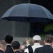 In this July 10, 2015 photo, a member of the security detail holds an umbrella over Pope Francis upon his arrival to the Silvio Pettirossi International airport in Asuncion, Paraguay. Francis is now in Paraguay, where he's set to spend three days for the last stop of his South America tour. Paraguay's government declared Friday and Saturday national holidays in honor of the pope's visit. (AP Photo/Victor R. Caivano)