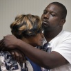 Aubrey DuBose, right, holds his mother Audrey during a news conference after murder and manslaughter charges against University of Cincinnati police officer Ray Tensing were announced for the traffic stop shooting death of motorist Samuel DuBose, Wednesday, July 29, 2015, in Cincinnati. Hamilton County Prosecutor Joseph Deters added that the officer "purposely killed him" and "should never have been a police officer." (AP Photo/John Minchillo)