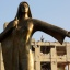 An Egyptian plainclothes policeman stands on top of the damaged national security building after a bomb exploded early Thursday, Aug. 20, 2015, in the Shubra el-Kheima neighborhood of Cairo, injuring several people, Egyptian security officials said. The statue represents an Egyptian farmer. (AP Photo/Amr Nabil)