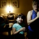 In this July 2, 2015 photo, Yaritza Pizano, 4, left, prays alongside her grandmother, Maria Marquez, in their home in the community of Okieville, on the outskirts of Tulare, Calif. As Yaritza's family began to run out of available water in 2014, she began to pray for it during her nightly prayer. "God, give us water so we don't have to move," the 4-year-old says, pressing her palms together. "God, please fill up our tank, so we don't run out of water," she said in a recent prayer. (AP Photo/Gregory Bull)
