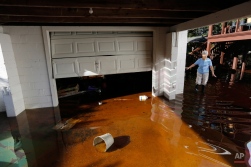 Roberta Albers walks around her home after the floodwaters start to recede at French Quarter Creek in Huger, S.C., Wednesday, Oct. 7, 2015. French Quarter Creek is prone to flooding, but all residents who have lived there for several decades say this is the worst it has ever been. (AP Photo/Mic Smith)