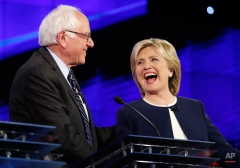 Sen. Bernie Sanders, of Vermont,, left, and Hillary Rodham Clinton laugh during the CNN Democratic presidential debate, Tuesday, Oct. 13, 2015, in Las Vegas. (AP Photo/John Locher)