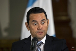 President elect Jimmy Morales makes a face during a press conference in Guatemala City, Monday, Oct. 26, 2015. Now that the former comedian has ridden a tide of voter frustration to win Guatemala's presidency, it remains unclear what the political neophyte might do once in office. The 46-year-old Morales, who is to assume the presidency Jan. 14 and has never held political office, said he would work with a transition team to study economic issues and work on development-oriented policies. (AP Photo/Luis Soto)