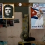 A poster of Pope Francis hangs next to a picture of revolutionary hero Ernesto "Che" Guevara, center, and Fidel Castro inside a government-run store that sells flour and beans in Havana, Cuba, Friday, Sept. 18, 2015. Francis delivered an unprecedented televised message to the Cuban people on Thursday night ahead of a four-day trip to the island, telling them on state television that Jesus "never abandons us" and he "loves you very much." (AP Photo/Ramon Espinosa)