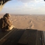 An Emirati gunner watches for enemy fire from the rear gate of a United Arab Emirates Chinook military helicopter flying over Yemen on Sept. 17, 2015. In Yemen’s Marib province, a key battleground in the fighting against Shiite rebels, frustration is growing in the ranks of troops backing the country’s president-in-exile after more than a week without gains on the ground. (AP Photo/Adam Schreck, File)