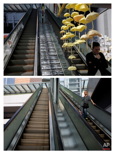 This combination of Nov. 21, 2014 file, top, and Sept. 26, 2015 photos shows a man walking past yellow paper umbrellas hanging above an escalator in an area occupied by protesters outside government headquarters during the Umbrella Movement in Hong Kong, and a man coming down the same escalator almost a year later. (AP Photo/Vincent Yu, File)