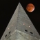 The so-called supermoon passes behind the peak of the Washington Monument during a lunar eclipse, Sunday, Sept. 27, 2015. The supermoon, or perigee moon, occurs when the full or new moon comes closest to the Earth making it appear bigger. t's the first time the events have made a twin appearance since 1982, and they won't again until 2033. (AP Photo/J. David Ake)