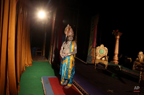 An Indian actor dressed as Rama, the main character of the Hindu epic Ramayana, prepares to perform at a theatre in Bangalore, India, Monday, Nov. 2, 2015. The performance was self-funded by a group of artists who do other jobs for a living. (AP Photo/Aijaz Rahi)
