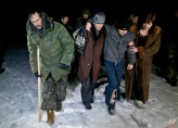 Russia-backed separatists, some injured, walk on a snowy road in no man's land after being released by the Ukrainian military in a prisoner exchange, near Zholobok, Ukraine, Saturday, Feb. 21, 2015. Ukrainian military and separatist representatives exchanged dozens of prisoners under cover of darkness at a remote frontline location Saturday evening. 139 Ukrainian troops and 52 rebels were exchanged, according to a separatist official overseeing the prisoner swap at a no man’s land location near the village of Zholobok, some 20 kilometers (12 miles) west of Luhansk. (AP Photo/Vadim Ghirda)