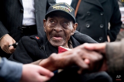 Pearl Harbor survivor and D-Day veteran Frank Levingston Jr., of Lake Charles, La., who at 110 is believed to be America's oldest military veteran, is greeted by visitors following a wreath laying ceremony to mark the anniversary of Pearl Harbor at the World War II Memorial, Monday, Dec. 7, 2015, in Washington. The surprise attack on Pearl Harbor in 1941 by the Japanese killed 2,403 Americans and was the catalyst for the United States to become involved in World War II. (AP Photo/Andrew Harnik)