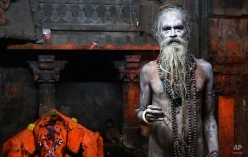 A Naga sadhu, or naked Hindu holy man, poses for a picture after taking a holy dip in the Godavari River during Kumbh Mela, or Pitcher Festival, at Trimbakeshwar in Nasik, India, Sunday, Sept. 13, 2015. Hindus believe taking a dip in the waters of a holy river during the festival, will cleanse them of their sins. According to Hindu mythology, the Kumbh Mela celebrates the victory of gods over demons in a furious battle over a nectar that would give them immortality. (AP Photo/Rafiq Maqbool)