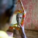 In this July 15, 2015 photo, Colas Etienne looks at her reflection, inside her home in Deron, a neighborhood on the outskirts of Pestel, Haiti. Colas Etienne was a shadow at the very edge of Mariette William's memories, a daughter who had been adopted by a Canadian couple in 1986. Through social media Mariette found Colas, the mother she never knew. (AP Photo/Dieu Nalio Chery)