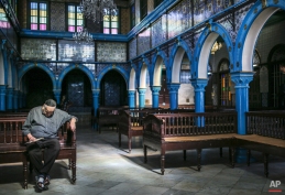In this Wednesday, Oct. 28, 2015 photo, a Jewish man rests in La Ghriba, the oldest synagogue in Africa, on the Island of Djerba, southern Tunisia. The Jewish community in the resort island of Djerba traces its roots all the way back to Babylonian exile of 586 B.C., and is one of the few communities of its kind to have survived the turmoil around the creation of Israel, when more than 800,000 Jews across the Arab world either emigrated or were driven from their homes. (AP Photo/Mosa'ab Elshamy)