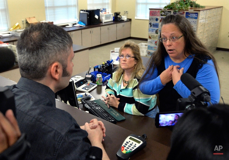 Rowan County Clerk Kim Davis, right, talks with David Moore following her office's refusal to issue marriage licenses at the Rowan County Courthouse in Morehead, Ky., Tuesday, Sept. 1, 2015. Although her appeal to the U.S. Supreme Court was denied, Davis still refused to issue marriage licenses. (AP Photo/Timothy D. Easley)
