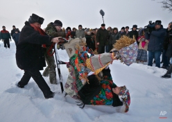 Belarusians wearing national costumes celebrate a Pull the Kolyada Up the Oak rite in the village of Martsiyanauka, some 77 km (48 miles) east of capital Minsk, Belarus, Thursday, Jan. 21, 2016. The merry ancient rite Pull the Kolyada Up the Oak marks the end of Orthodox Christmas celebrations in Belarus. On Jan. 21 a wheel, the so-called Kolyada, would be pulled up an oak or any old tree. The Belarusians believed that the ritual heralds a good harvest, luck and happiness for the entire year. (AP Photo/Sergei Grits)