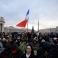 A woman holds up a French flag as she waits in St. Peter's Square for the start of a mass celebrated by Pope Francis on the occasion the opening of the Holy Door of St. Peter's Basilica, at the Vatican, Tuesday, Dec. 8, 2015. Francis on Tuesday pushes open the huge bronze Holy Door to formally launch his yearlong "revolution of tenderness" amid unprecedented security aimed at thwarting the threat of a Paris-style attack at the Vatican. (AP Photo/Gregorio Borgia)