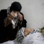 Najah al-Atrash mourns over the body of her son Saad al-Atrash during the mass funeral of 17 Palestinians in the West Bank city of Hebron, Saturday, Jan. 2, 2016. On Friday the Israeli military transferred almost two dozen bodies of Palestinians it says were involved in violence over the past few months to their families in the West Bank. In October, Israel began withholding the bodies of suspected attackers as a tactic meant to crack down on the violence. (AP Photo/Majdi Mohammed)
