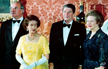 In a June 10, 1984 photo, Britain's Queen Elizabeth II, second left, stands with, West German Chancellor Helmut Kohl, left, U.S. President Ronald Reagan, second right, and Britain's Prime Minister Margaret Thatcher at London's Buckingham Palace, prior to a dinner for summit leaders. (AP Photo)